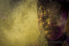 <p><strong>2017 ––India -Uttar Pradesh – Mathura - Holi Festival</strong></p>
<p>L’Holi Festival commemora la vittoria del bene sul male, in particolare il rogo e la distruzione di un demone femmina, un’orchessa di nome Holika.</p>
<p><em>Suo nipote, Prahlad, era il figlio del Re dei demoni Hiranyakashipu: questi non sopportava che il proprio figlio venerasse il dio Vishnu più del suo stesso padre e per questo affronto lo punì con castighi atroci. Per finirlo definitivamente, la sorella del re, Holika, vestita di un mantello protettivo, tentò di uccidere Prahlad gettandosi nel fuoco insieme al nipote; il mantello invece protesse Prahlad, avvolgendo nelle fiamme la zia cattiva. Da questa leggenda, nasce la tradizione del fuoco di Holika che si celebra la notte prima di Holi: le famiglie indiane accendono dei piccoli falò chiamati Holi ka Dahan, a simboleggiare la vittoria del Bene sul Male, mentre decine di guru praticano il rito del camminare sulle braci per dimostrare di essere dalla parte delle divinità benevole. </em></p>
<p>Dopo le fiamme arrivano i colori: il giorno successivo è il vero e proprio Holi Day.</p>
<p>Migliaia di persone inondano piazze, luoghi di culto, vie della città vecchia per cantare, danzare e contemporaneamente affrontare una vera e propria battaglia pacifica a colpi di ciprie colorate, tinture e qualsiasi cosa possa macchiare corpi e visi. Questa esplosione di gioia richiama i festeggiamenti per la sconfitta di Holika, ma l’uso delle polveri colorate è legato a Krishna, una divinità importante nel pantheon religioso indù, che a <strong>Mathura</strong> nacque nel Luglio del 3227 a.C.</p>
<p>La grande storia di amore di Krishna e Radha nacque e crebbe nella periferia di Mathura: innamorato della bella Radha, dalla pelle candida e amareggiato per il colore scuro della propria pelle, Krishna decise di dipingersi il volto di tanti colori per rendersi più attraente e conquistarla. Il festival celebra l'amore di Krishna per Radha, bellissima gopi, pastorella del villaggio di V?ndavana che diverrà compagna eterna del dio.</p>